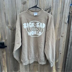 The "Sick Sad World" graphic on the crewneck sweatshirt Size XL